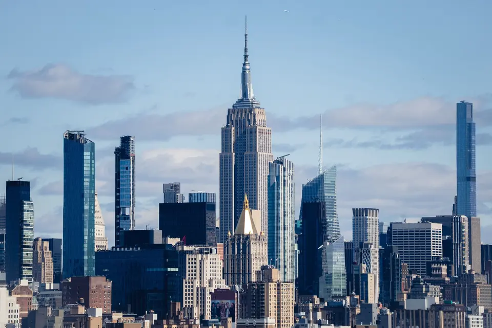 Close telephoto view of the Empire State Building surrounded by high-rise towers